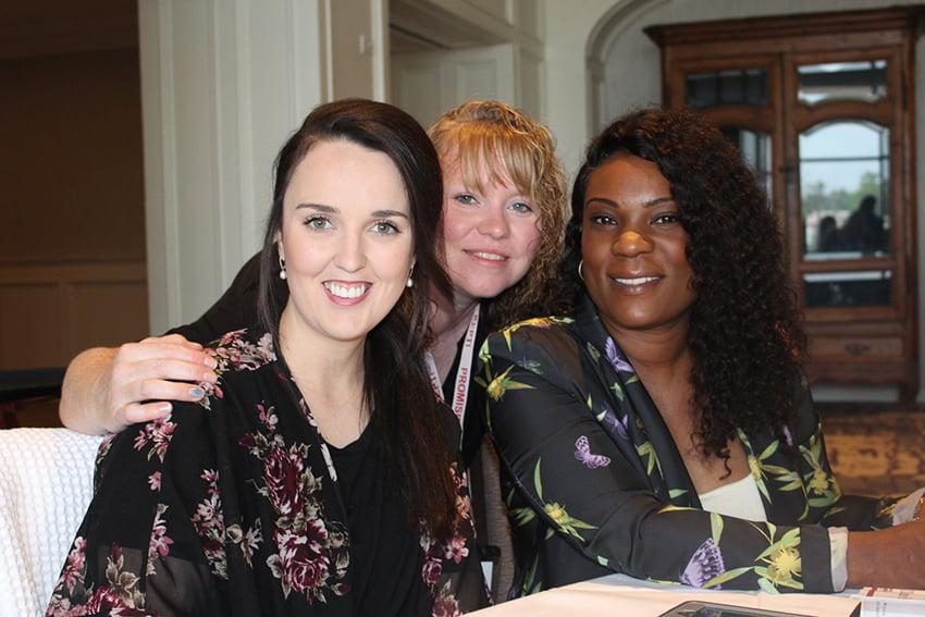 Three ladies smiling.